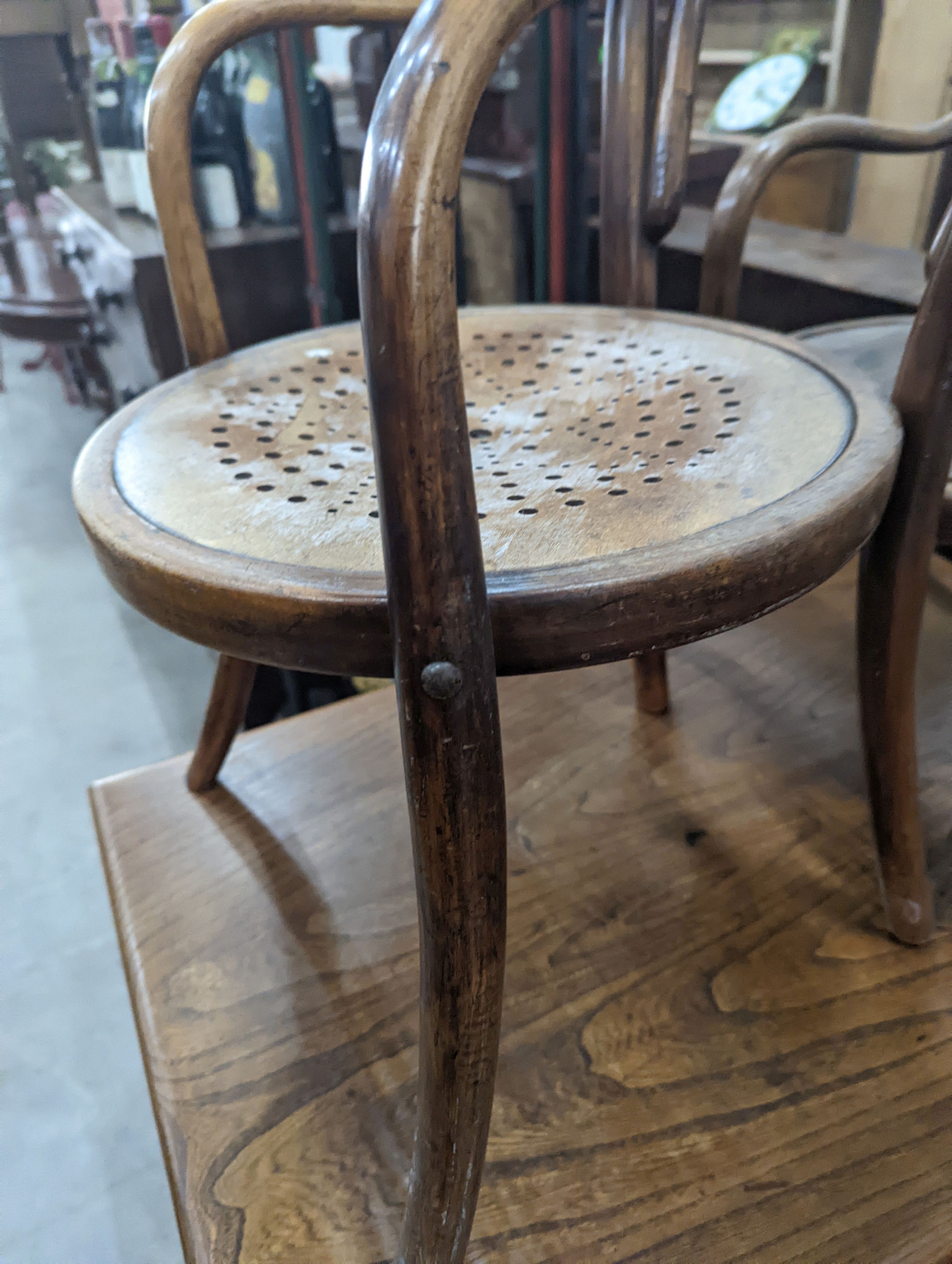 A near pair of early 20th century beech bentwood childs elbow chairs